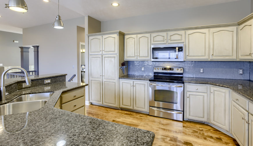 Off white updated kitchen with granite countertops